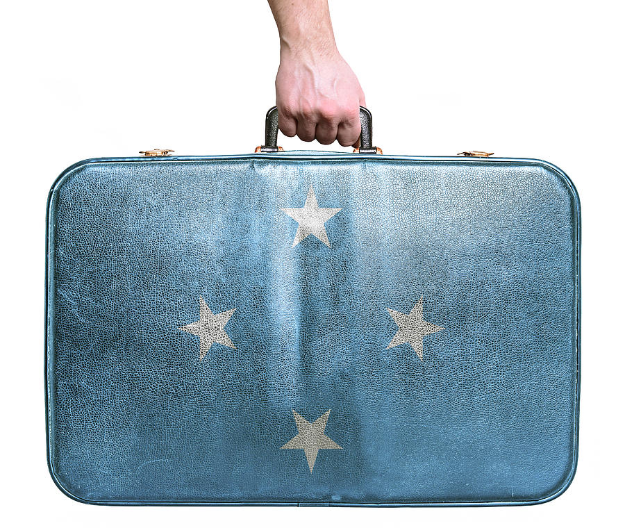 Tourist hand holding vintage travel bag with flag of Micronesia Photograph by Alexis84