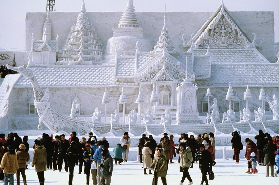 Tourist in front of a snow sculpture, Bangkoks Royal Palace, Snow Festival, Sapporo, Japan Photograph by Glowimages