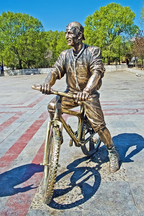 Tourist on a Bicycle Sculpture on a Plaza in Shigatse Tibet by Ruth Hager