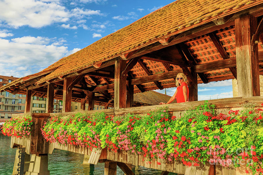 Tourist on Lucerne flowery bridge Photograph by Benny Marty