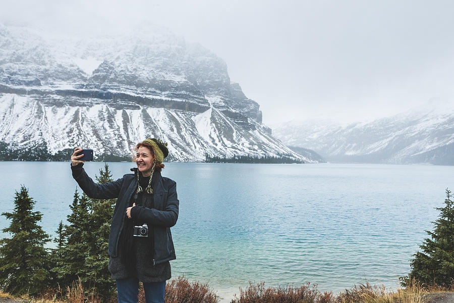 Tourist taking a Selfie in the Canadian Rocky Mountains Photograph by Powerofforever