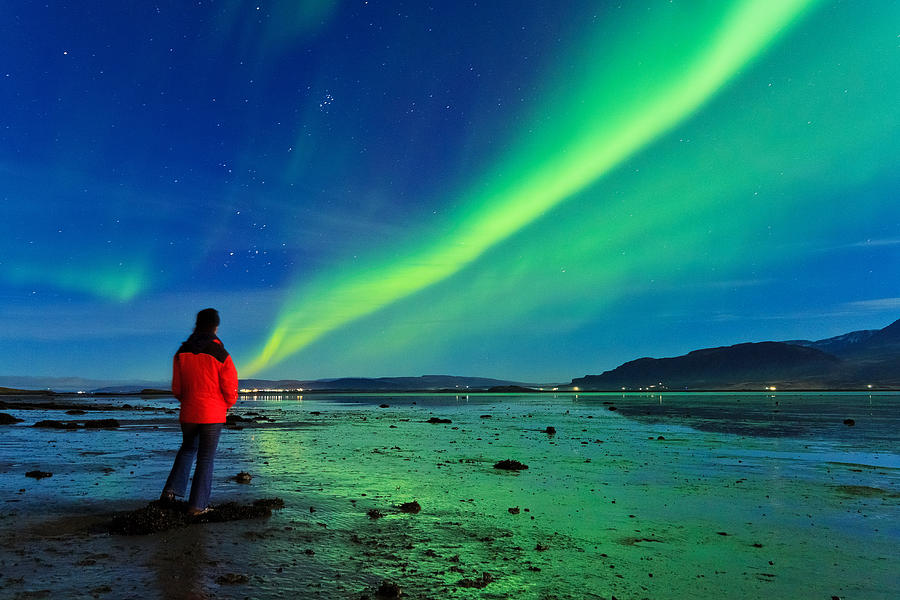 Tourist watches Aurora over fjord, Iceland Photograph by Anna Gorin