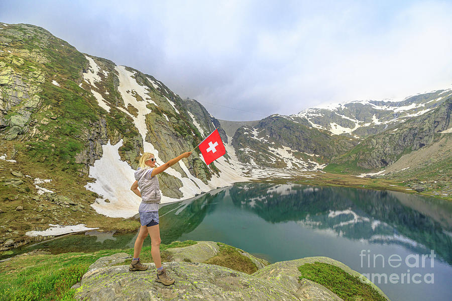 Tourist woman by Lago Bianco lake with swiss flag Photograph by Benny Marty