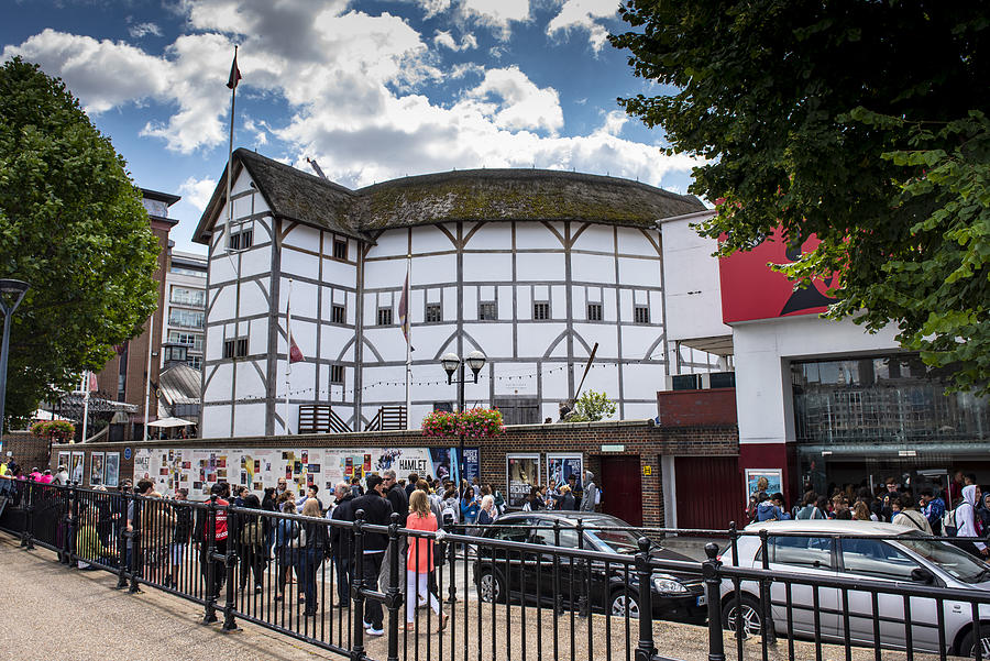 Tourists and locals walking beside Shakespeares Globe theatre in London, England. Photograph by Steve-goacher