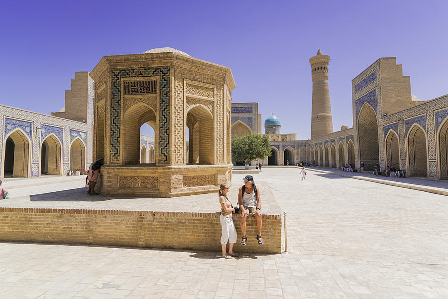 Tourists at courtyard of Kalyan Mosque in Bukhara, Uzbekistan Photograph by DavorLovincic