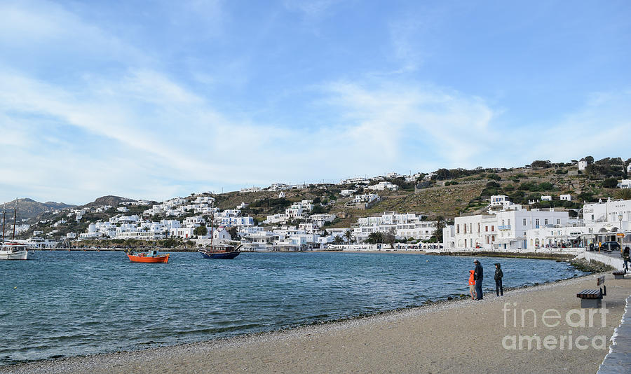 Tourists enjoy the port area at Mykonos Town, Mykonos, Greece in Photograph by William Kuta