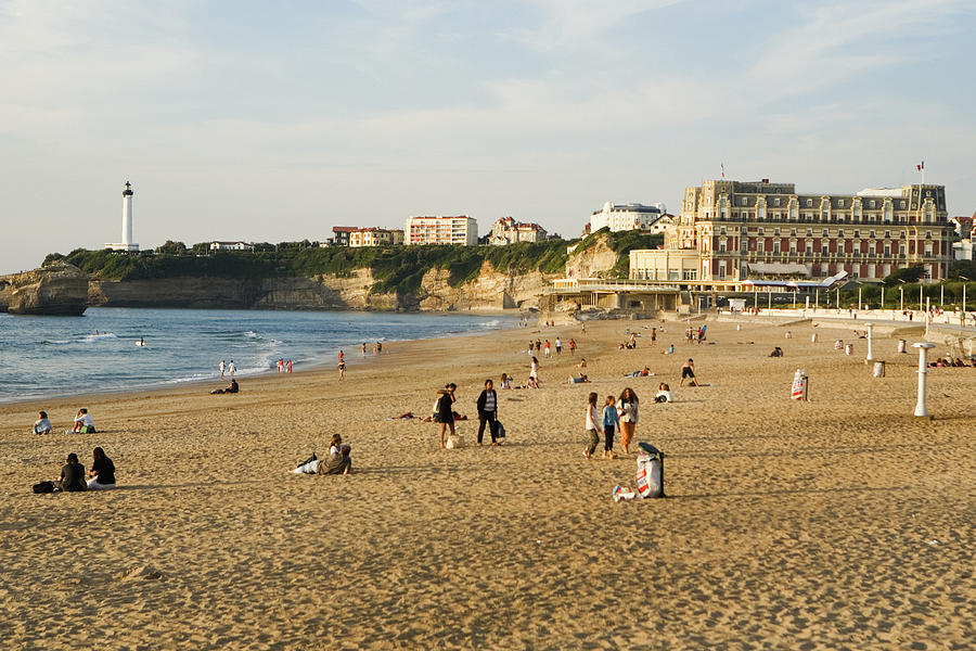 Tourists on the beach, Phare de Biarritz, Hotel du Palais, Grande Plage, Biarritz, France Photograph by Glow Images