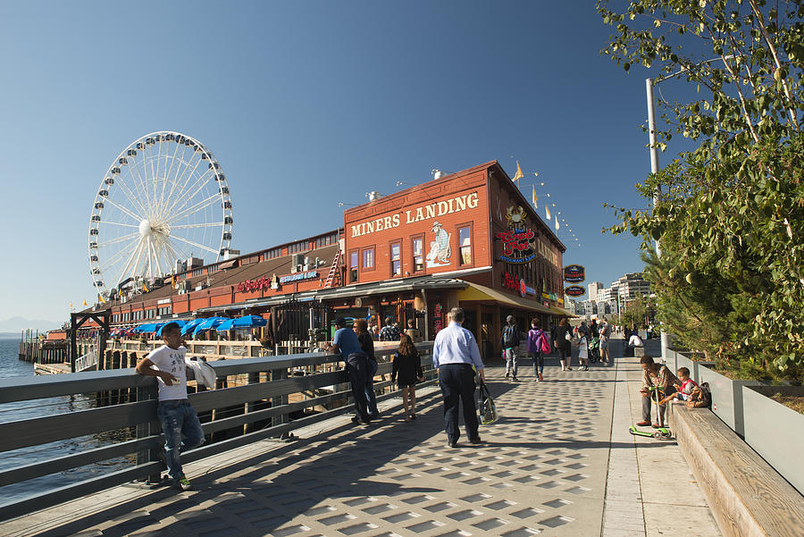 Tourists on waterfront walk at Pier 57 in Seattle Photograph by Aimintang