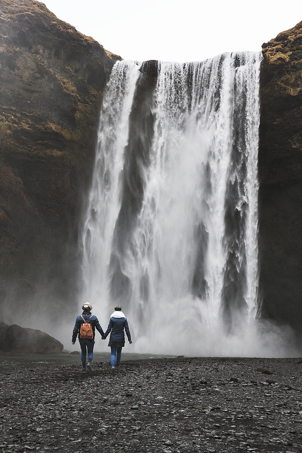 Tourists Visiting Skógafoss Waterfall at Skógar in Iceland Photograph by Powerofforever