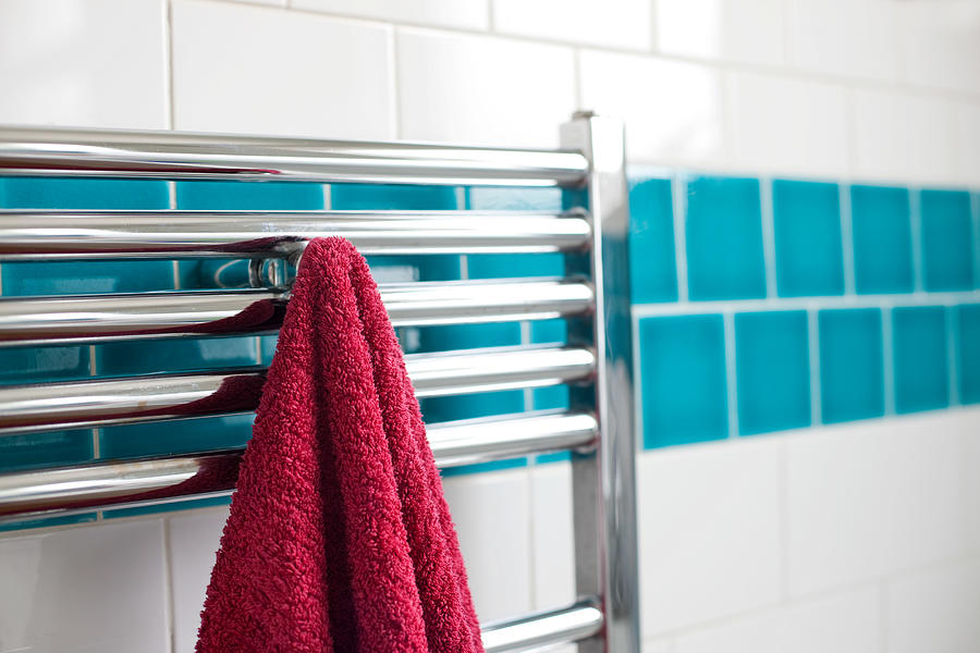 Towel hanging on a rail in bathroom Photograph by Image Source