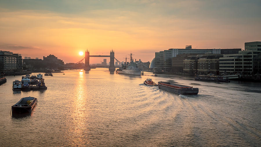 Tower Bridge at sunrise with a barge moving along the river Thames, London, UK Photograph by Doug Armand