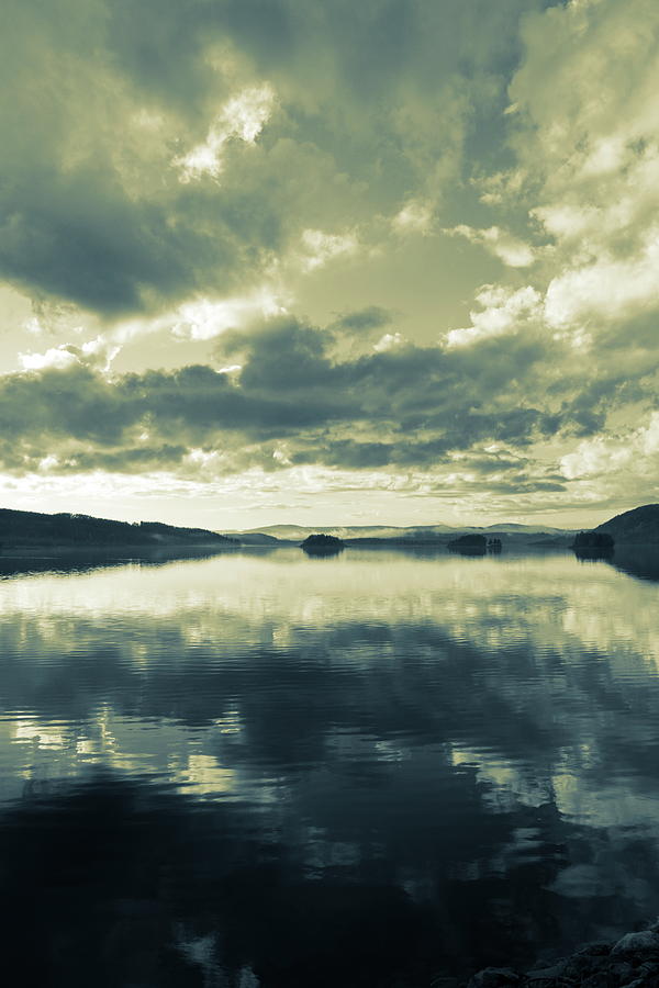 Towering clouds are reflected in a quiet lake - duotone Photograph by Ulrich Kunst And Bettina Scheidulin