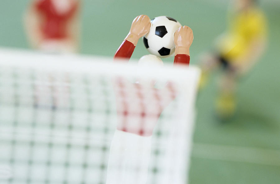 Toy figurine playing football, Tipp Kick, blurred image Photograph by Achim Sass