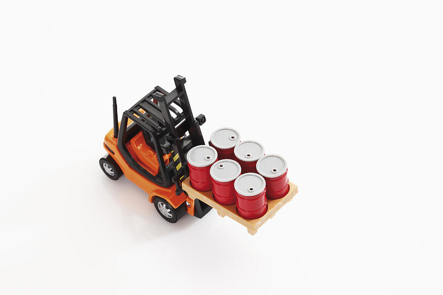 Toy forklift truck carrying barrels on white background, elevated view Photograph by Tuned_In