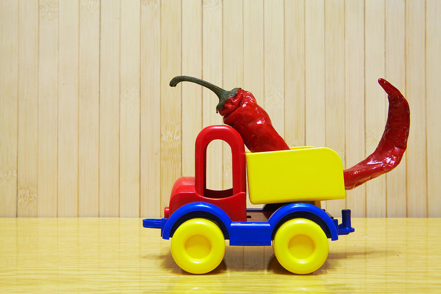 Toy plastic car with red pepper Photograph by Ukrainec