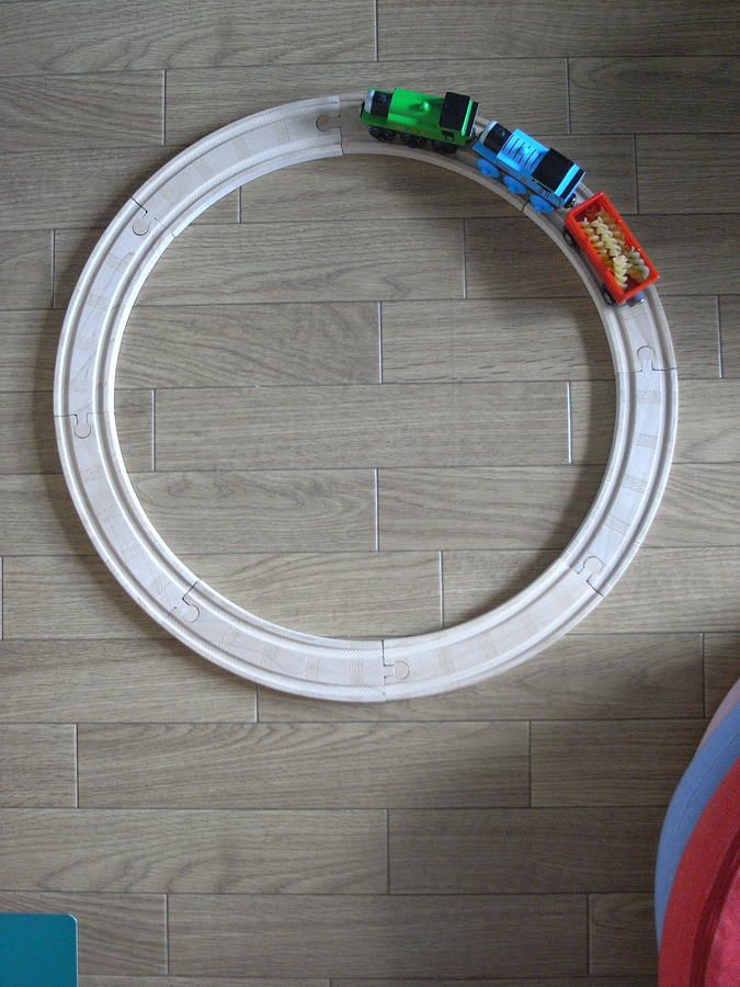 Toy train carrying pasta on circular track Photograph by Lucinda Newton-Dunn