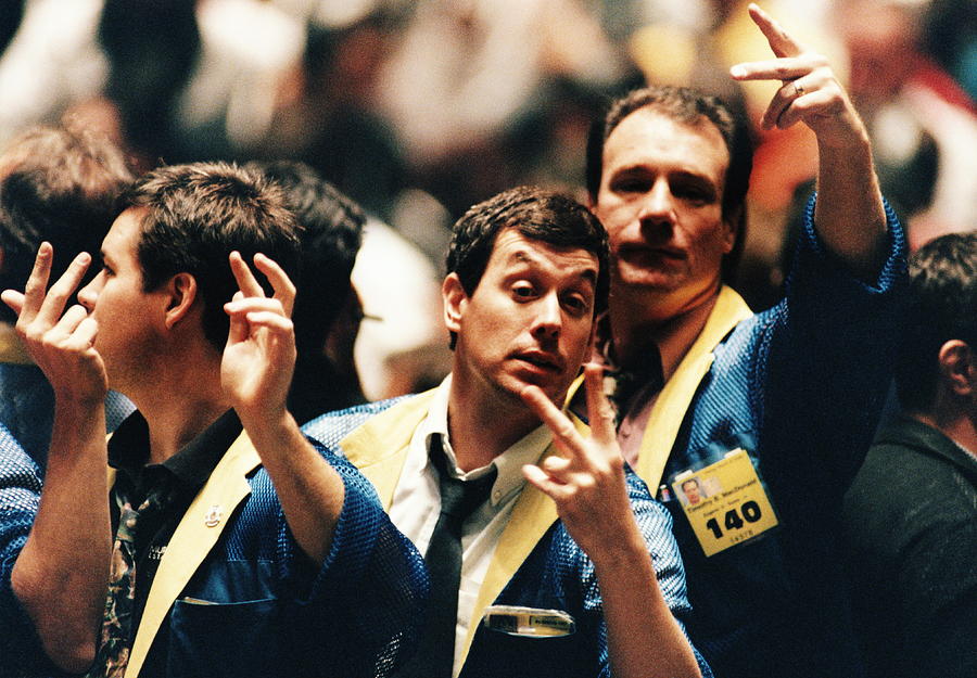 Traders gesturing on stock trading floor, USA Photograph by Jonathan Kirn