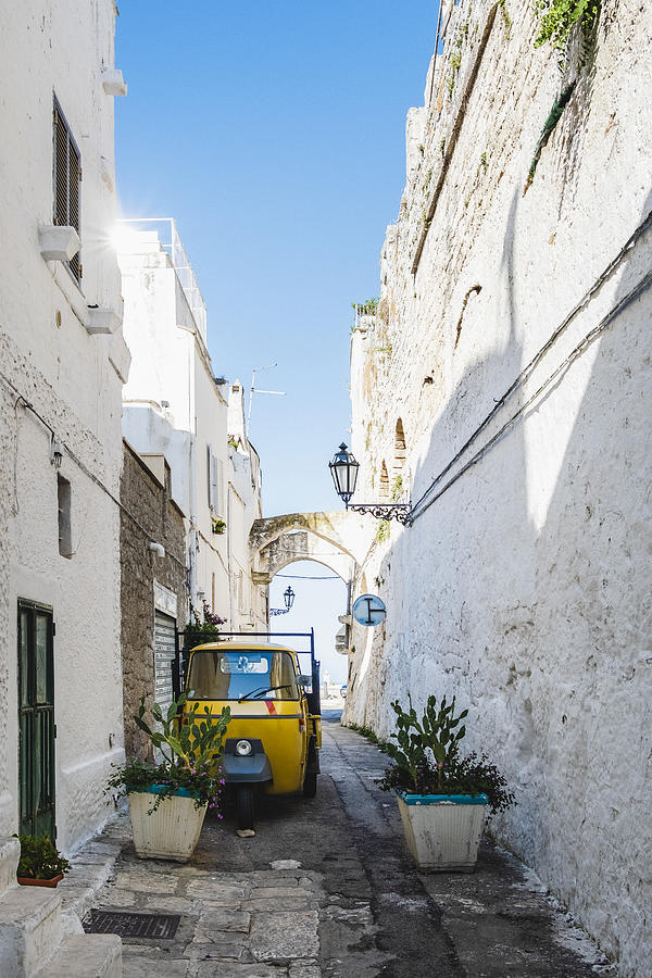 Traditional alley with three-wheeler in the city of Ostuni, Puglia, Italy Photograph by Massimo Colombo