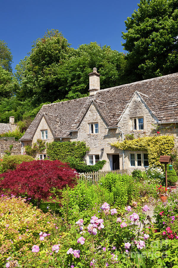 Traditional cottages and flower garden, Bibury, the Cotswolds, England Photograph by Neale And Judith Clark