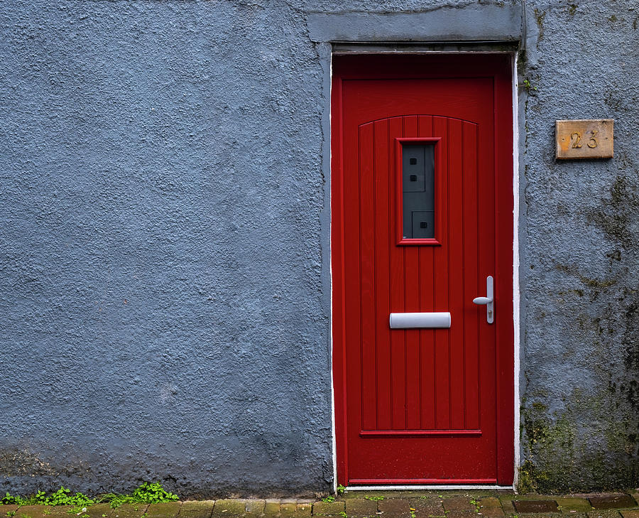 Traditional English house facade front entrance with red closed door . Photograph by Michalakis Ppalis