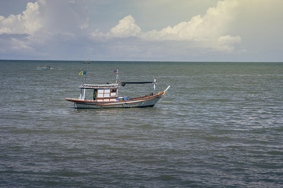 Traditional Fishing Boat Laying On The Sea Photograph by IttoIlmatar