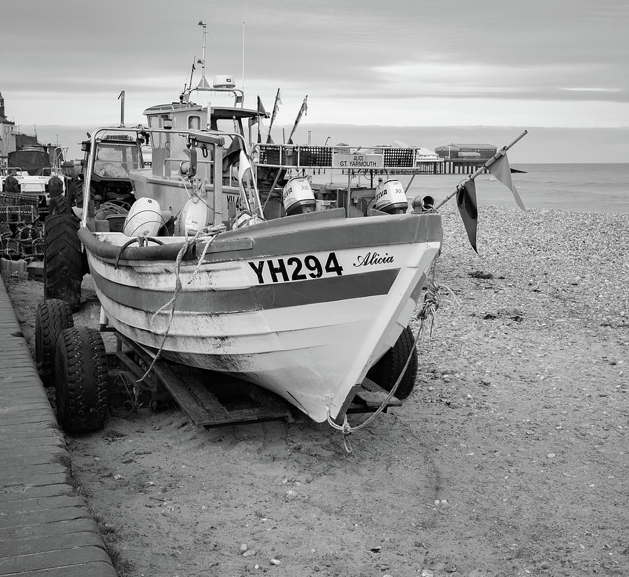 Traditional fishing boat on Cromer beach in black and white Photograph by Chris Yaxley