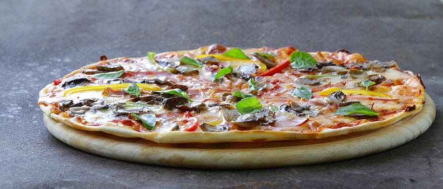 traditional Italian pizza with mushrooms, peppers and pancetta Photograph by Olgakr