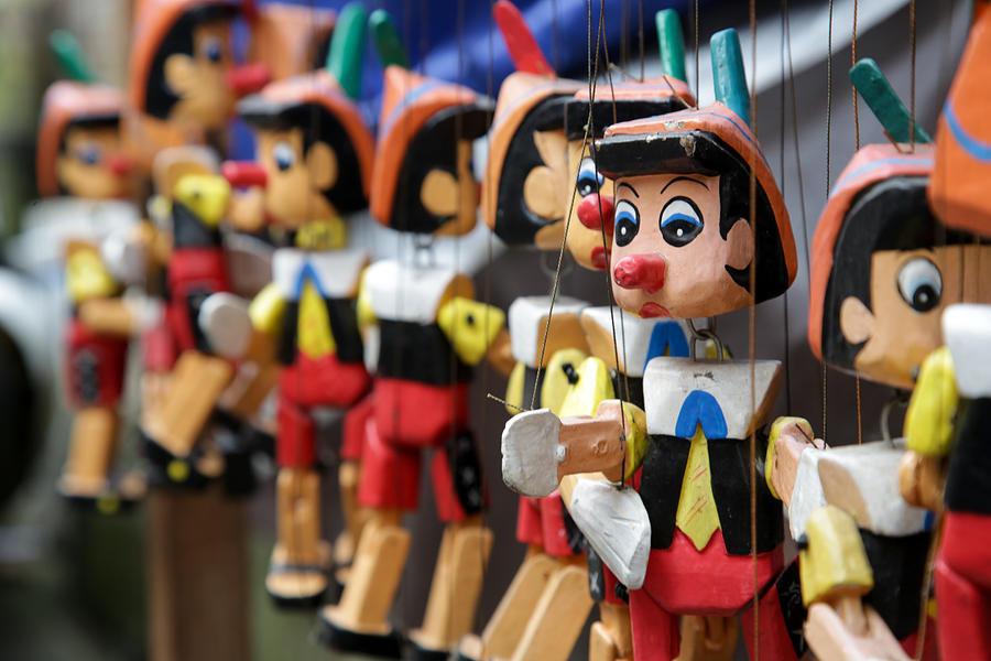 Traditional wooden Pinocchio toy on the market Photograph by Triocean