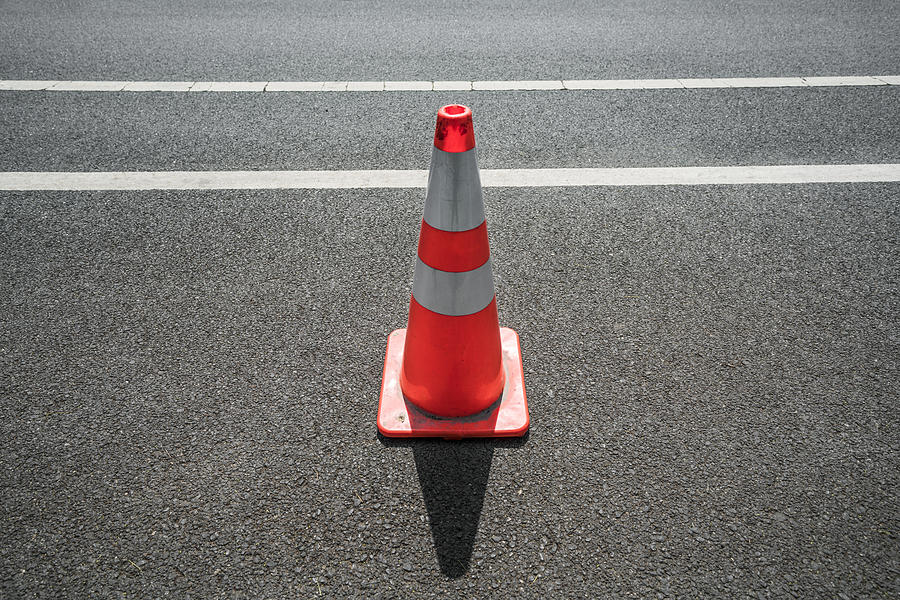 Traffic cone,an image of cautions on asphalt road Photograph by Xinzheng