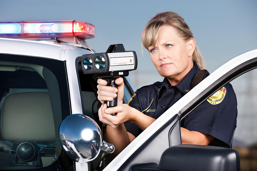 Traffic Enforcement: Woman Police Officer with Laser Gun Photograph by Avid_creative