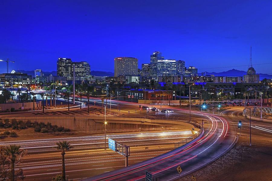 Traffic Streaks Below the Phoenix Skyline Photograph by David Kadlubowski