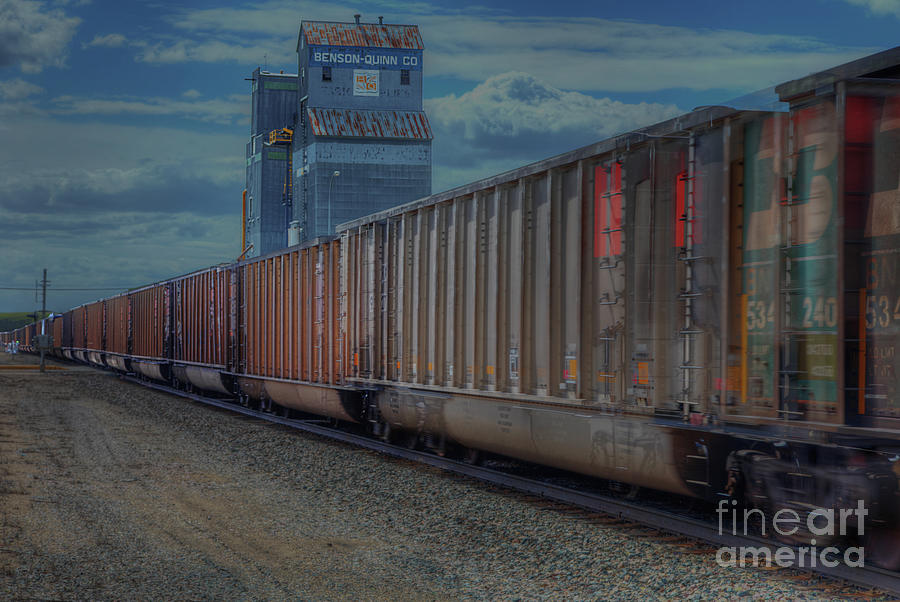 Train Photograph - Train moving by an Grain Elevator   by Larry Braun