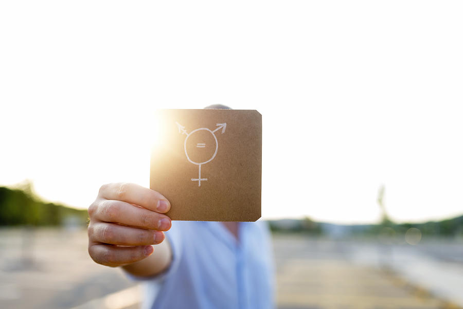 Transgender symbol on piece of paper Photograph by Ljubaphoto