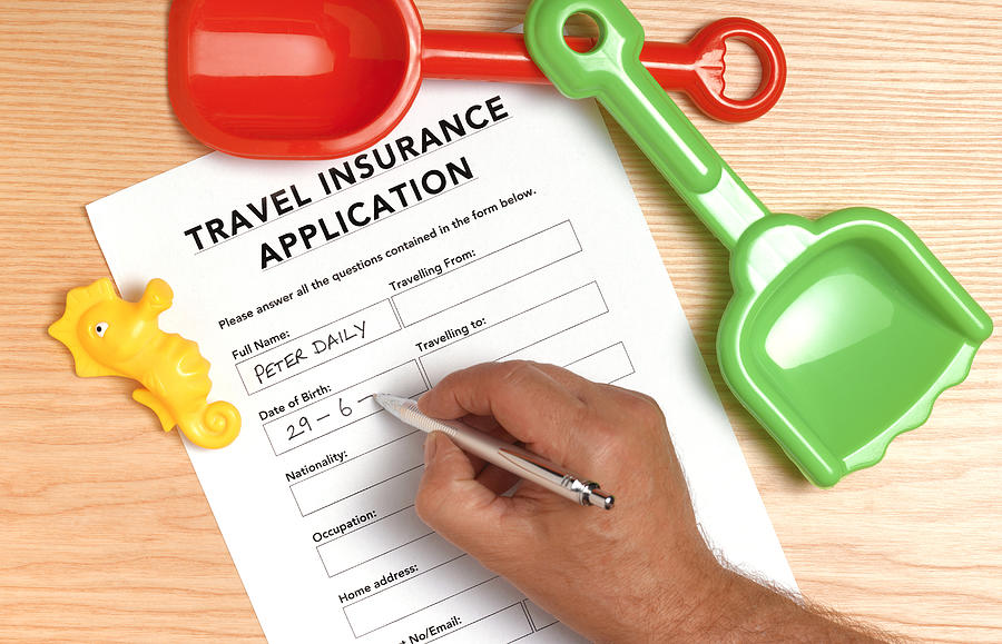 Travel insurance application Photograph by Peter Dazeley