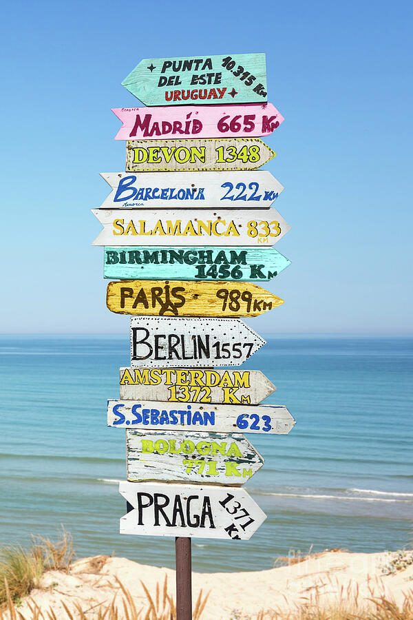 Travel direction signs on the beach  Photograph by Delphimages Photo Creations