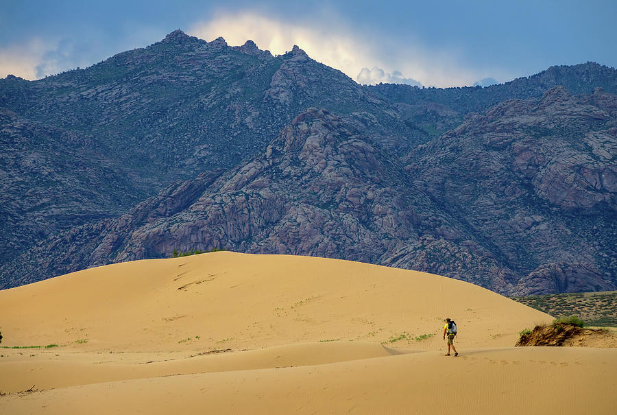 Traveler in desert dunes in mountains Photograph by Mikhail Kokhanchikov