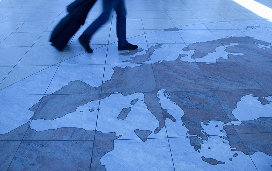 Traveler walking on Europe map floor Photograph by Grant Faint