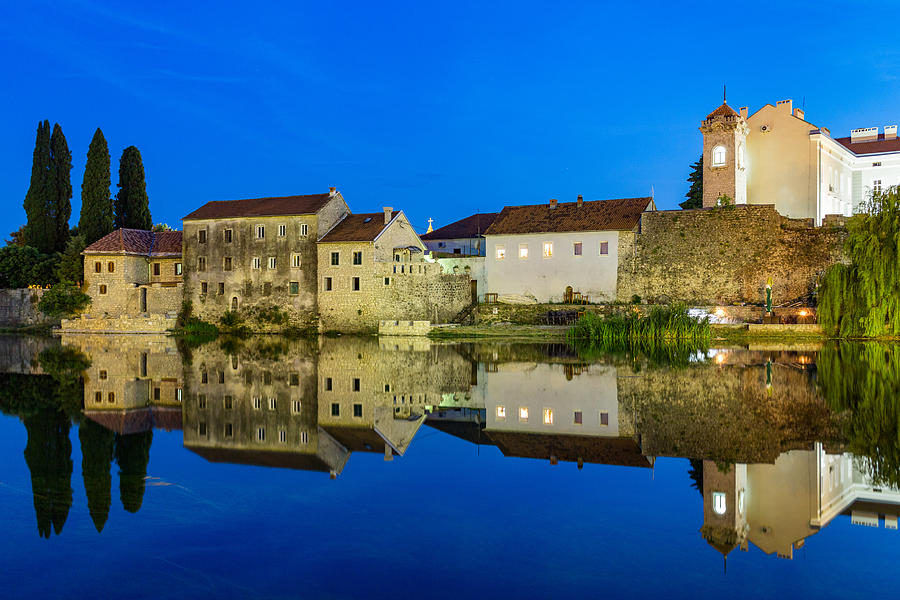 Trebinje reflected in the Trebišnjica river at night, Bosnia and Herzegovina Photograph by Frans Sellies