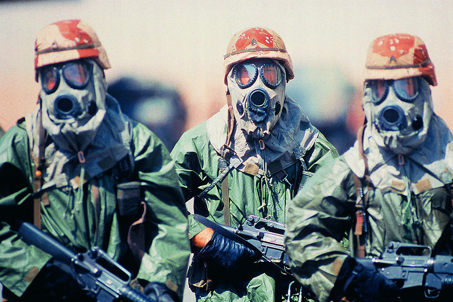 Troop of soldiers in camouflage uniforms, helmets and gas masks Photograph by Frank Rossoto Stocktrek