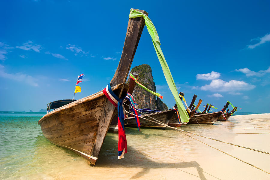 Tropical beach landscape. Thai long tail boats at ocean coast Photograph by ImPerfectLazybones