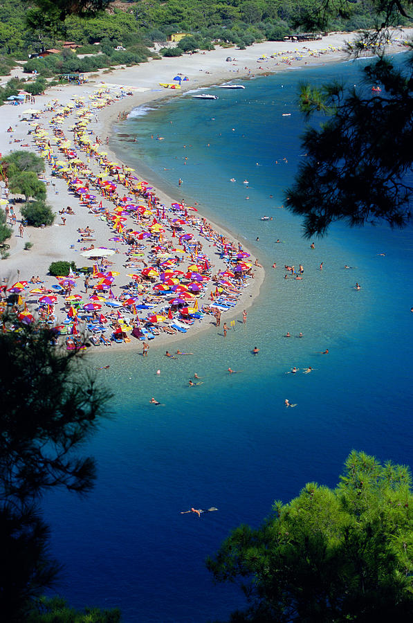Tropical beach populated with sunbathers, elevated view Photograph by Sakis Papadopoulos