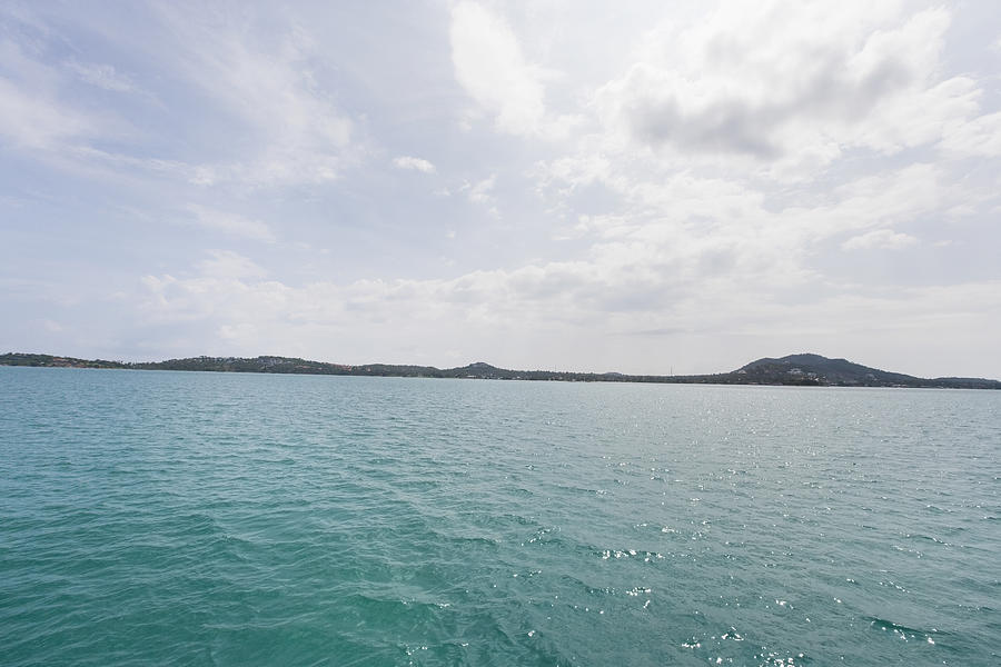 Tropical blue sea with island in background; Koh Samui; Thailand Photograph by IPGGutenbergUKLtd