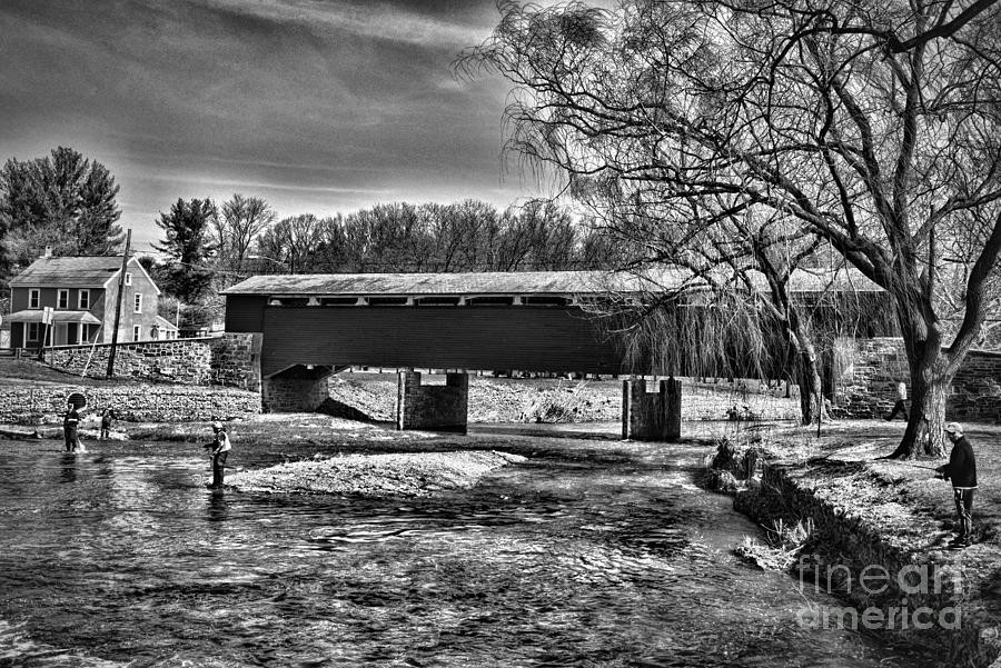 Trout Fishing at the Covered Bridge black and white Photograph by Paul Ward