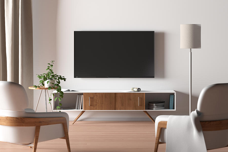TV screen on the white wall in modern living room. Photograph by Dmitriymoroz