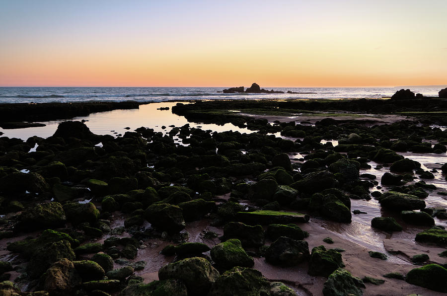 Twilight and rocks in Gale beach Photograph by Angelo DeVal