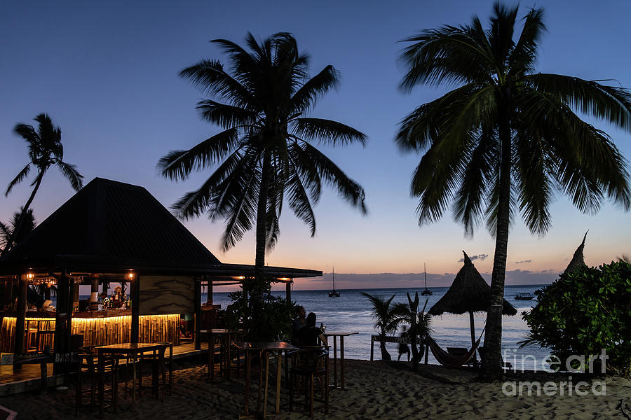 Twilight over a beach bar in the Waya island, part of the Yasawa Photograph by Didier Marti