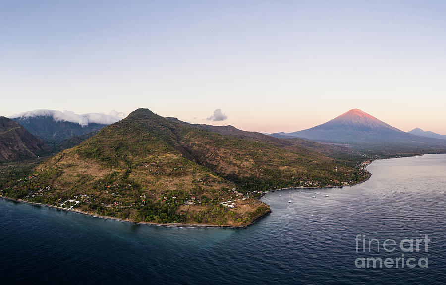 Twilight over the north Bali coast with the Agung volcano near A Photograph by Didier Marti