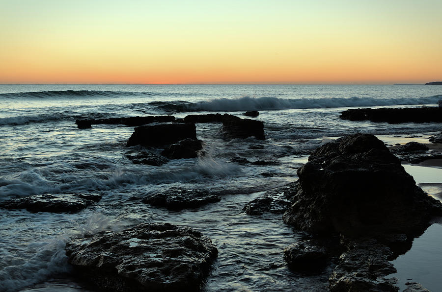 Twilight waves and rocks in Albufeira Photograph by Angelo DeVal