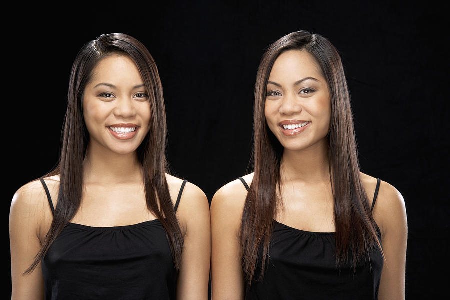 Twin sisters smiling, portrait Photograph by James Woodson