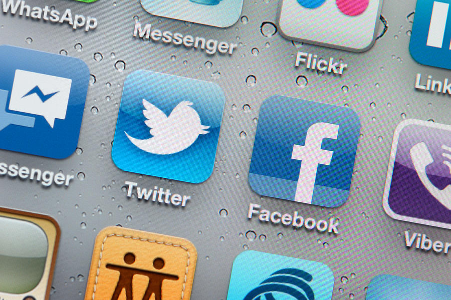 Twitter and Facebook icons on iPhone screen Photograph by Hocus-focus